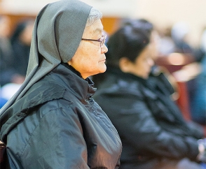 Nun in church service