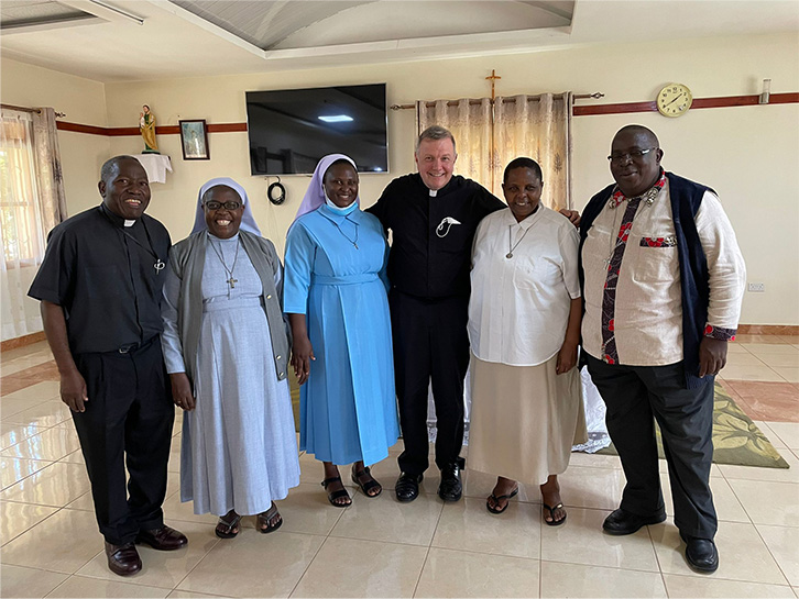 Group of nuns and priests standing and smiling