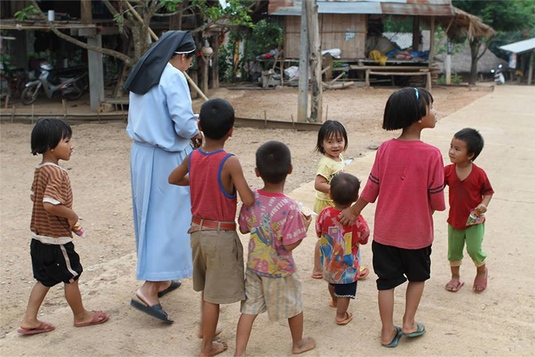 Nun walking with young kids
